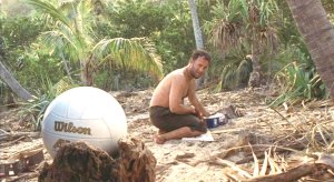 Tom Hanks as Chuck Noland in the film "Cast Away" along with his inanimate volleyball friend Wilson.