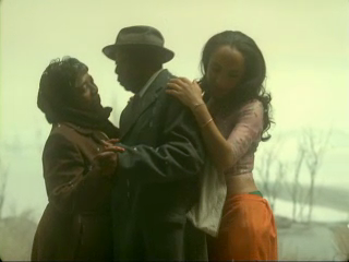 Sade sidles a dancing elderly couple: "You think I'd leave your side, baby? You know me better than that."